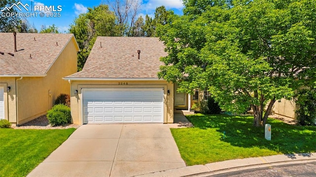 3245 Chestnut Glen Ln, Colorado Springs, CO 80918 - view of front of house with driveway, a front yard, an attached garage, a shingled roof, and stucco siding
