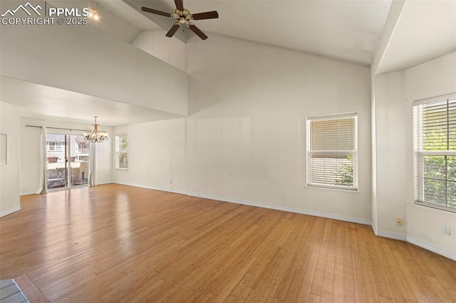 3245 Chestnut Glen Ln, Colorado Springs, CO 80918 - unfurnished living room featuring a chandelier, high vaulted ceiling, light wood finished floors, and a ceiling fan