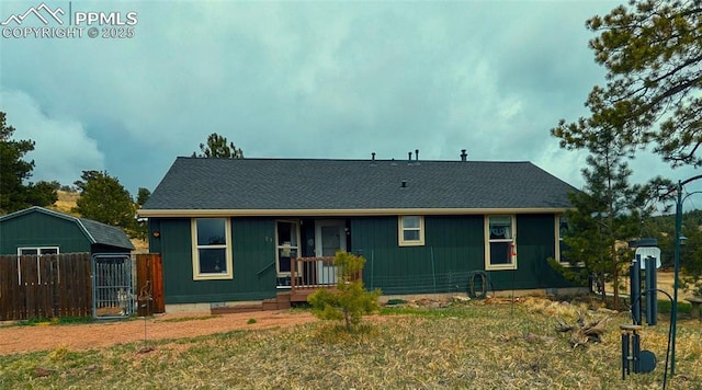 ranch-style house with fence