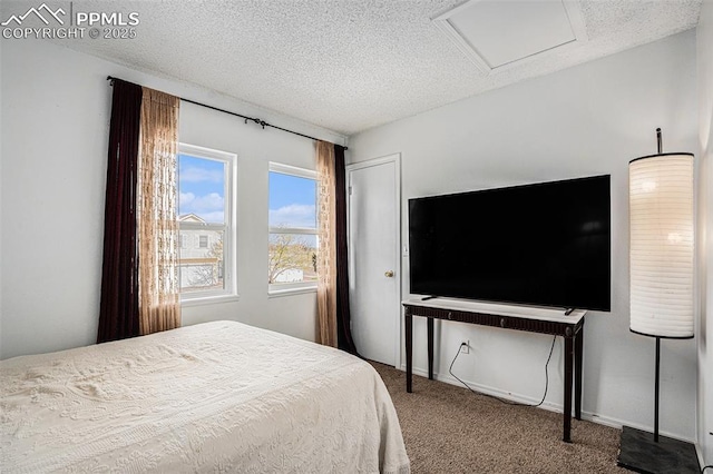3450 Galleria Ter, Colorado Springs, CO 80916 - bedroom featuring carpet, attic access, and a textured ceiling