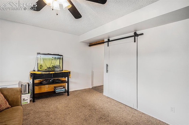 3450 Galleria Ter, Colorado Springs, CO 80916 - interior space featuring carpet floors, baseboards, a barn door, a textured ceiling, and a ceiling fan