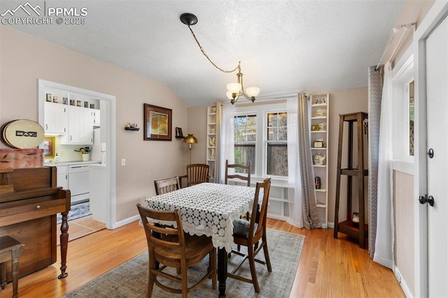 25 Highland St, Colorado Springs, CO 80906 - dining space featuring a chandelier, light wood-type flooring, lofted ceiling, and a textured ceiling