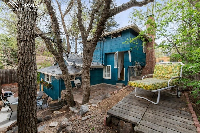 25 Highland St, Colorado Springs, CO 80906 - rear view of house featuring a chimney, a patio, and a deck