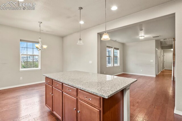 8806 Bella Flora Hts, Colorado Springs, CO 80924 - kitchen with wood finished floors, healthy amount of natural light, baseboards, and recessed lighting