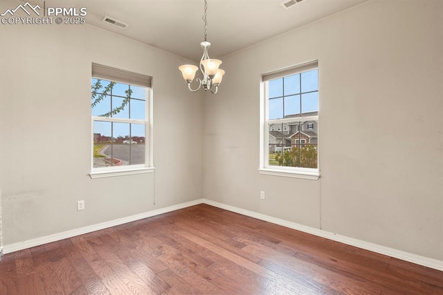 8806 Bella Flora Hts, Colorado Springs, CO 80924 - spare room featuring a chandelier, plenty of natural light, and wood finished floors