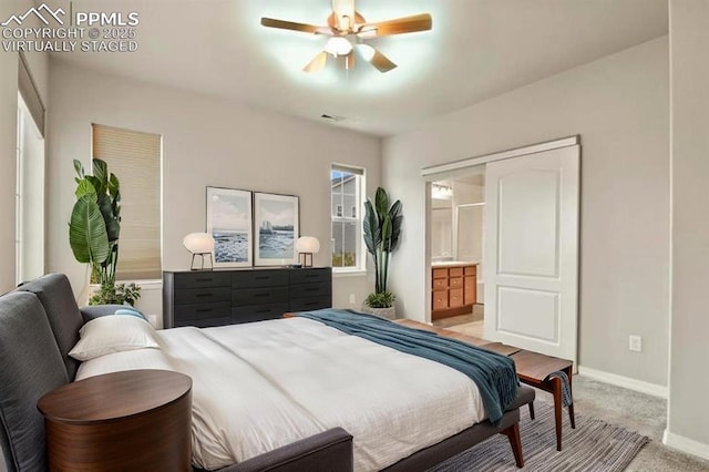 8806 Bella Flora Hts, Colorado Springs, CO 80924 - bedroom with baseboards, light colored carpet, ensuite bath, and a ceiling fan