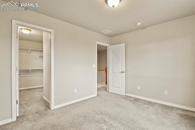 8806 Bella Flora Hts, Colorado Springs, CO 80924 - unfurnished bedroom featuring carpet floors, baseboards, a walk in closet, and a closet