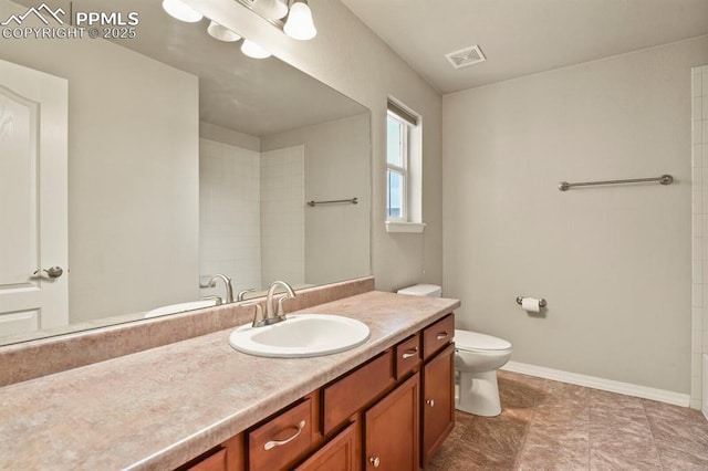 8806 Bella Flora Hts, Colorado Springs, CO 80924 - full bathroom featuring toilet, vanity, baseboards, and tiled shower