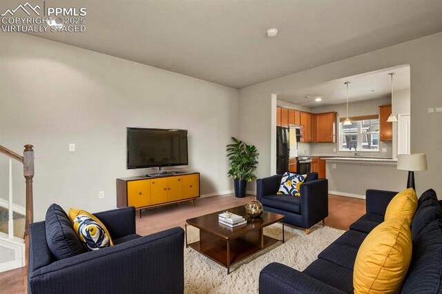 8806 Bella Flora Hts, Colorado Springs, CO 80924 - living room with stairs and baseboards
