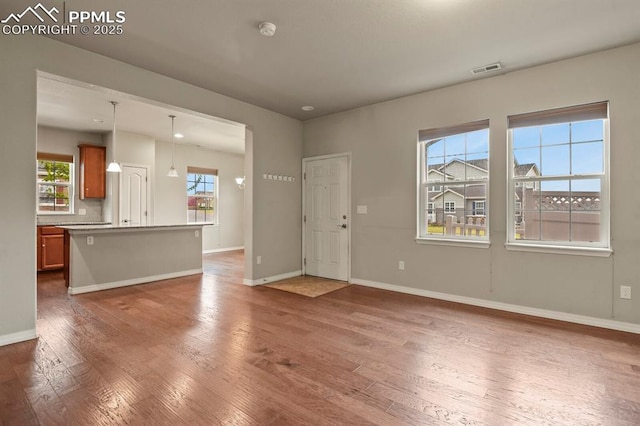 8806 Bella Flora Hts, Colorado Springs, CO 80924 - unfurnished living room with wood finished floors and baseboards