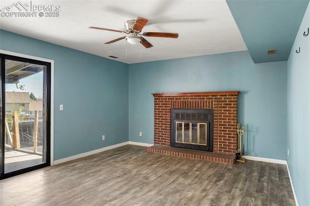 4720 Live Oak Dr, Colorado Springs, CO 80916 - unfurnished living room with wood finished floors, baseboards, ceiling fan, and a brick fireplace