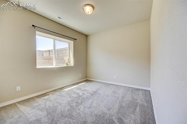 carpeted spare room with baseboards and visible vents