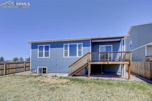 rear view of property with stairway, a deck, a yard, and a fenced backyard