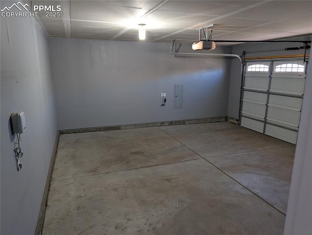 garage featuring baseboards, a garage door opener, and electric panel
