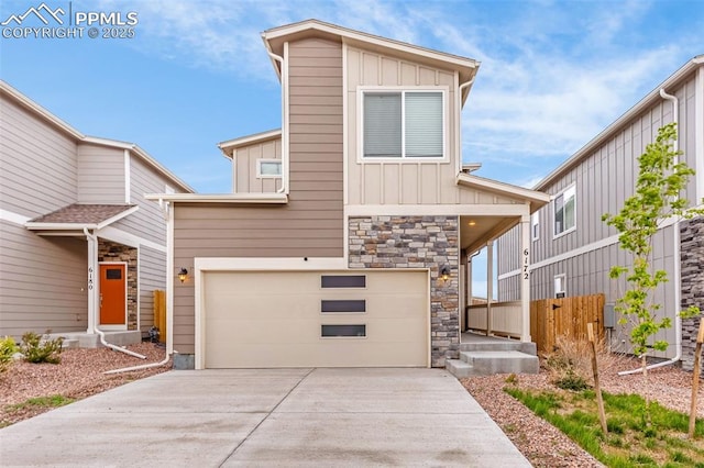 6172 Godwit Ln, Colorado Springs, CO 80925 - modern home featuring board and batten siding, a garage, concrete driveway, and stone siding