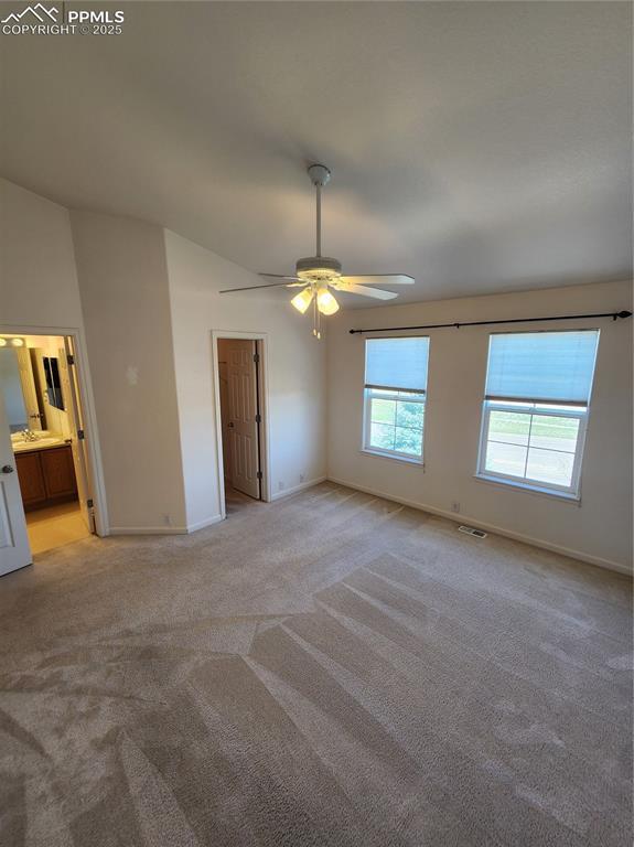 3928 Diamond Ridge Vw, Colorado Springs, CO 80918 - unfurnished bedroom featuring light carpet, baseboards, ceiling fan, and connected bathroom
