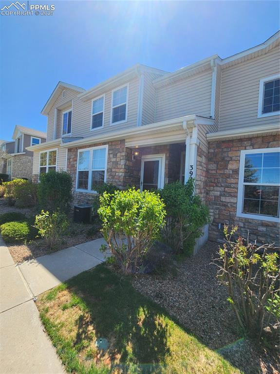 3928 Diamond Ridge Vw, Colorado Springs, CO 80918 - view of front facade with stone siding and central air condition unit