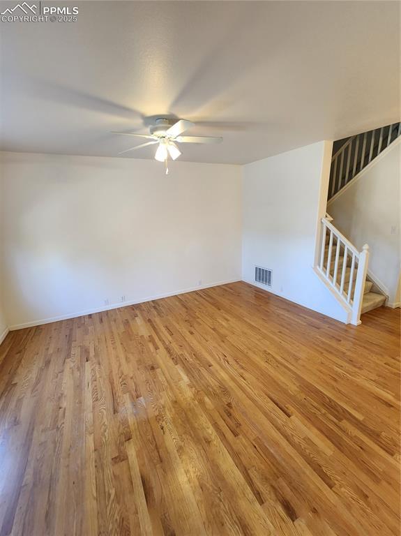 3928 Diamond Ridge Vw, Colorado Springs, CO 80918 - unfurnished living room with ceiling fan, wood finished floors, and baseboards