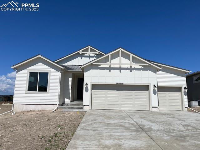 9378 Gallery Pl, Colorado Springs, CO 80924 - view of front of house featuring a garage, driveway, a standing seam roof, and metal roof
