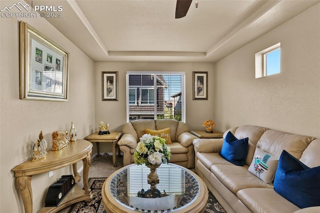 8356 Longleaf Ln, Colorado Springs, CO 80927 - carpeted living area with a ceiling fan and a raised ceiling
