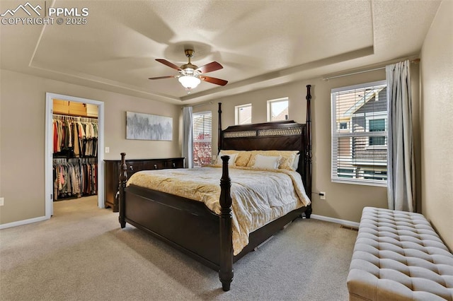 8356 Longleaf Ln, Colorado Springs, CO 80927 - bedroom featuring a tray ceiling, multiple windows, and light carpet