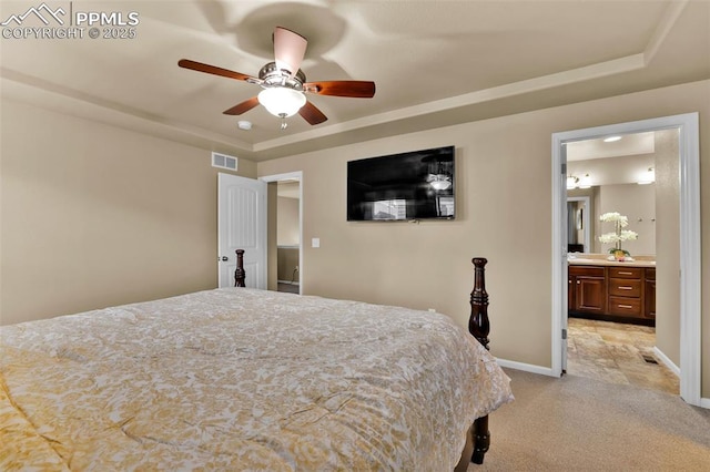 8356 Longleaf Ln, Colorado Springs, CO 80927 - bedroom with light colored carpet, a raised ceiling, connected bathroom, and baseboards