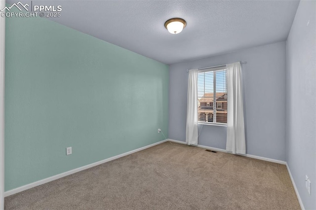 8356 Longleaf Ln, Colorado Springs, CO 80927 - carpeted empty room with baseboards, visible vents, and a textured ceiling