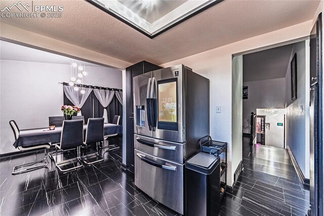 kitchen with marble finish floor, a notable chandelier, and stainless steel fridge with ice dispenser