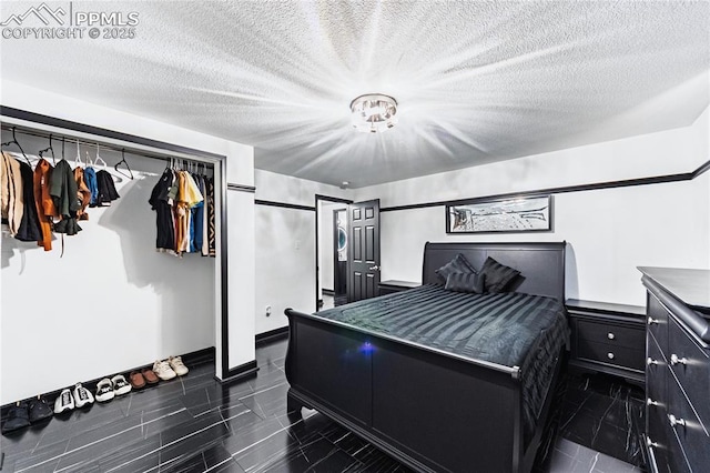 bedroom with baseboards and a closet