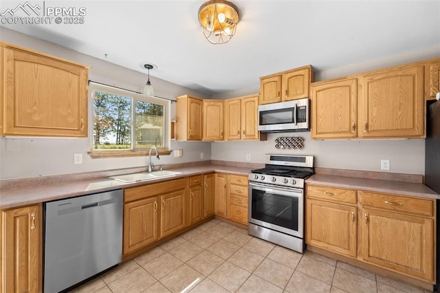 1151 Buttercup Rd, Elizabeth, CO 80107 - kitchen featuring appliances with stainless steel finishes, a sink, light tile patterned floors, pendant lighting, and light countertops