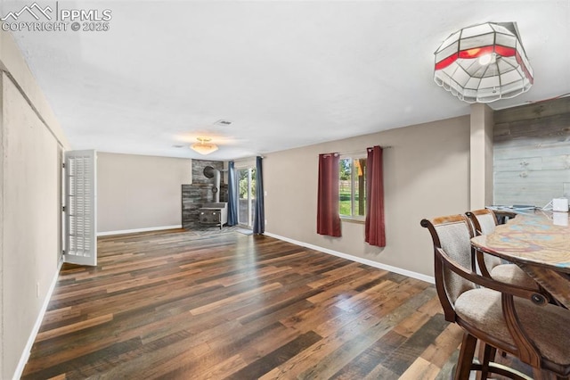 1151 Buttercup Rd, Elizabeth, CO 80107 - dining space featuring a wood stove, wood finished floors, and baseboards