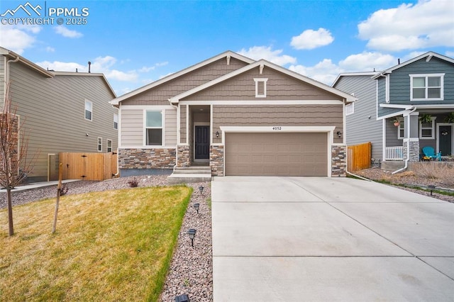 craftsman house featuring stone siding, a garage, fence, a front yard, and driveway