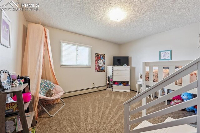 790 2nd Ave, Deer Trail, CO 80105 - bedroom with carpet floors, a baseboard heating unit, and a textured ceiling