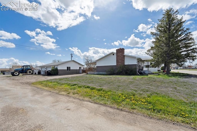 790 2nd Ave, Deer Trail, CO 80105 - view of side of home with a chimney and a yard