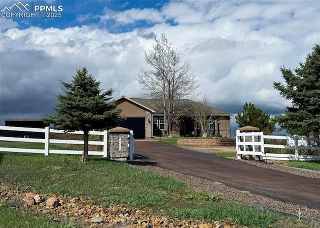 20420 Amanda Ct, Colorado Springs, CO 80908 - view of front facade featuring driveway, an attached garage, and stone siding