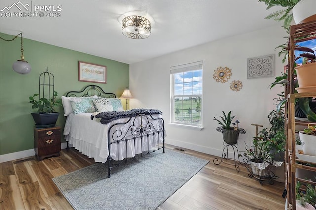 20420 Amanda Ct, Colorado Springs, CO 80908 - bedroom featuring wood finished floors and baseboards