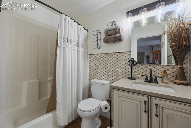 20420 Amanda Ct, Colorado Springs, CO 80908 - full bathroom featuring toilet, vanity, tile walls, shower / bath combo with shower curtain, and a wainscoted wall
