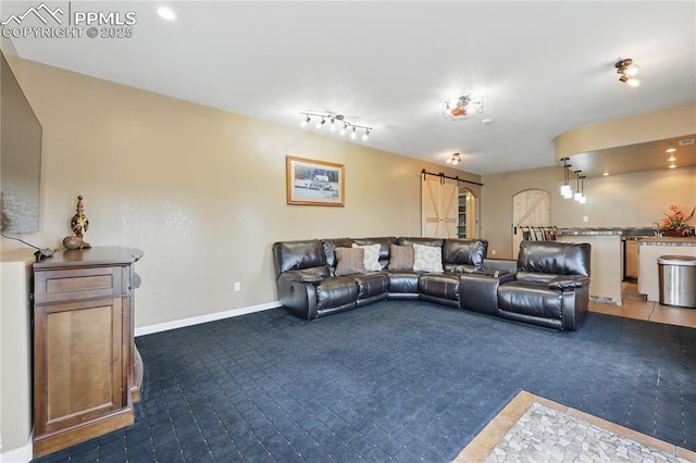20420 Amanda Ct, Colorado Springs, CO 80908 - carpeted living room with a barn door and baseboards