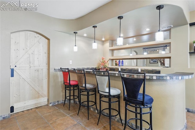 20420 Amanda Ct, Colorado Springs, CO 80908 - indoor wet bar with baseboards and pendant lighting