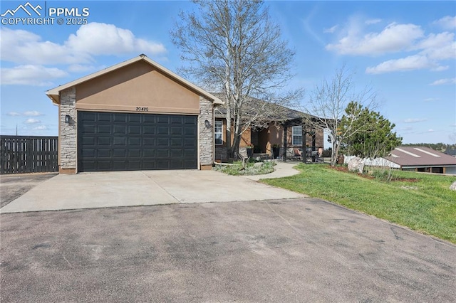 20420 Amanda Ct, Colorado Springs, CO 80908 - single story home with stone siding, a garage, concrete driveway, a front lawn, and stucco siding