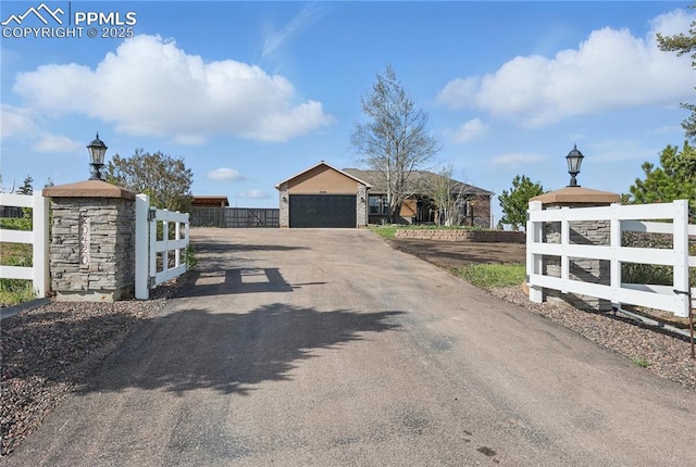 20420 Amanda Ct, Colorado Springs, CO 80908 - view of asphalt driveway featuring street lighting