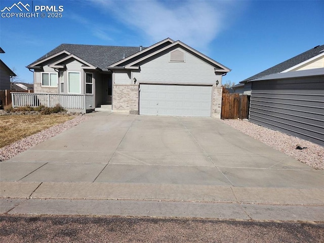 ranch-style home featuring brick siding, driveway, fence, and a garage