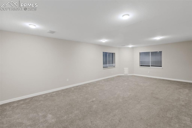carpeted spare room with baseboards