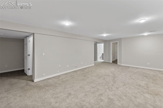 finished below grade area with baseboards and carpet flooring