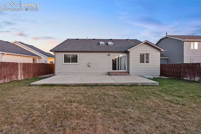 rear view of house featuring a lawn, a fenced backyard, and a patio area