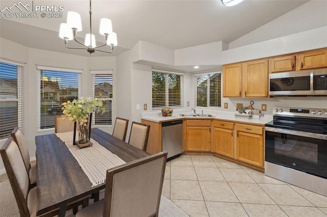 kitchen featuring a sink, light countertops, a chandelier, stainless steel appliances, and light tile patterned floors