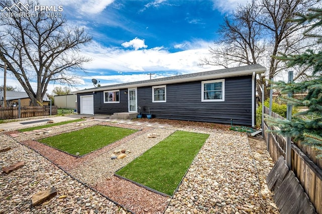 1085 6th St, Limon, CO 80828 - back of property with driveway, a fenced backyard, and a garage