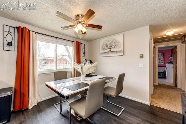1085 6th St, Limon, CO 80828 - dining space featuring dark wood-style flooring, baseboards, attic access, a textured ceiling, and a ceiling fan