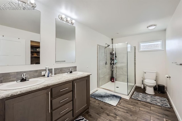 4157 Gray Fox Hts, Colorado Springs, CO 80922 - full bath with a sink, a stall shower, toilet, and wood finished floors