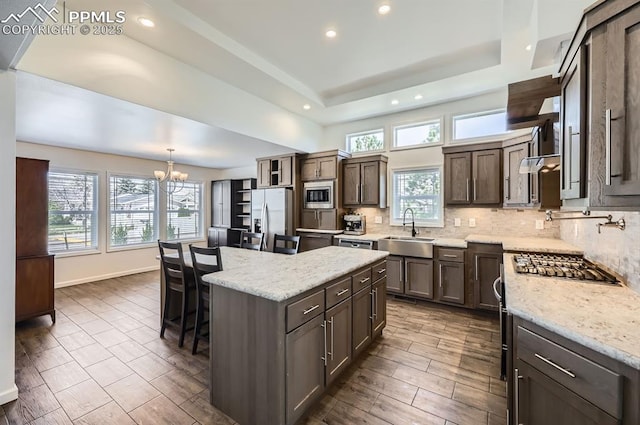 4157 Gray Fox Hts, Colorado Springs, CO 80922 - kitchen with appliances with stainless steel finishes, a sink, a chandelier, recessed lighting, and a kitchen island